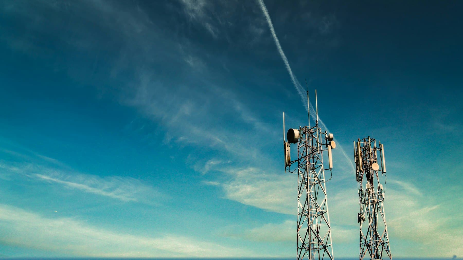 Cell towers against a clear blue sky